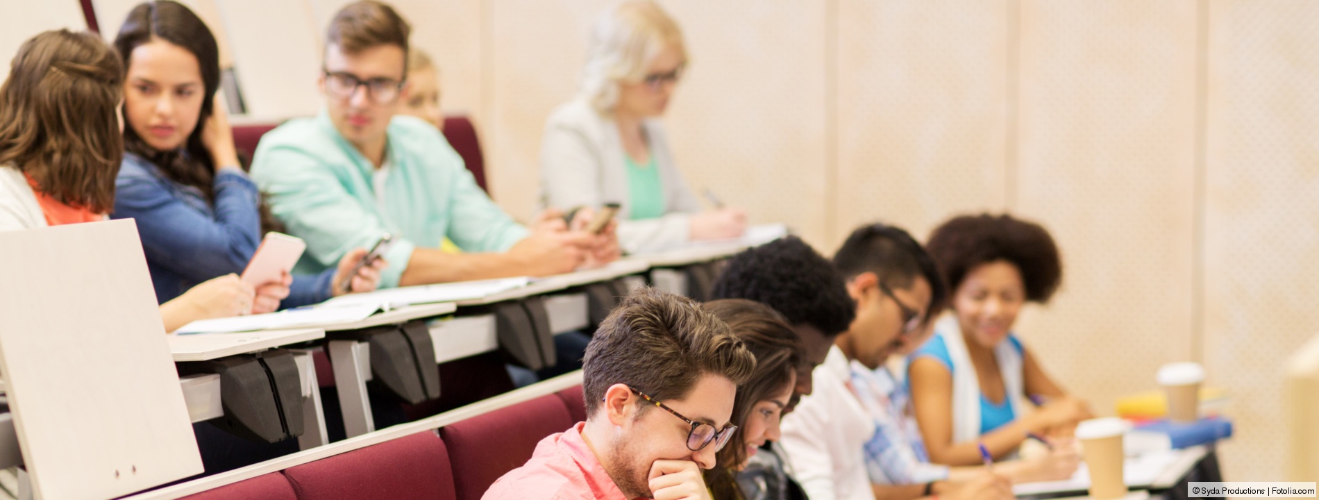 group of students with notebooks in lecture hall