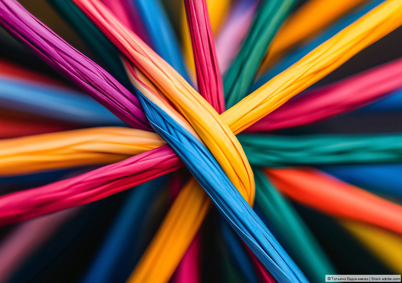 Colorful ropes are connecting together creating a network symbolizing synergy and teamwork Colorful ropes are connecting together creating a network symbolizing synergy and teamwork